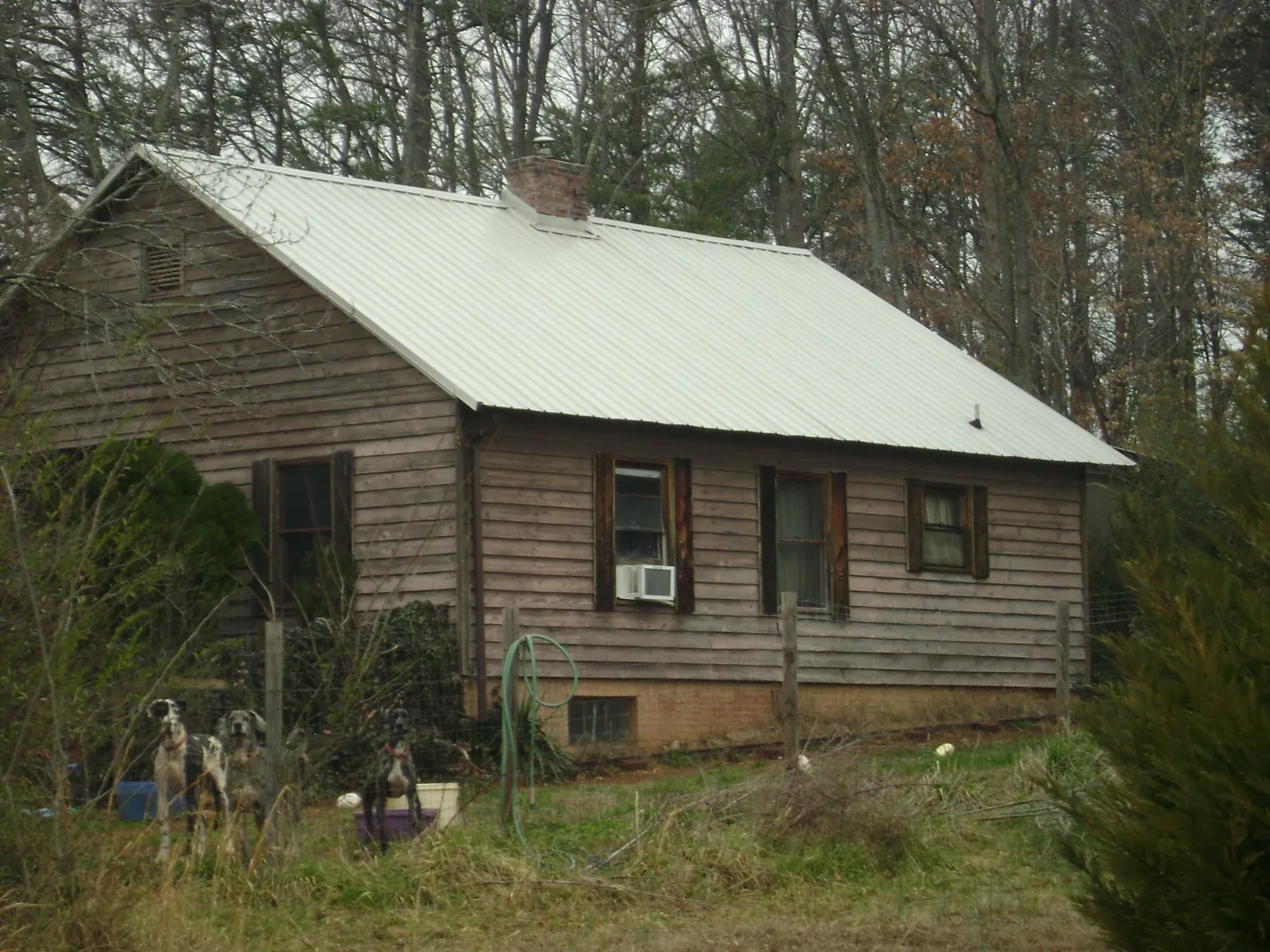 White metal roof on an old wood sided farmhouse, from a Metal Roof Installation job in Shrewsbury